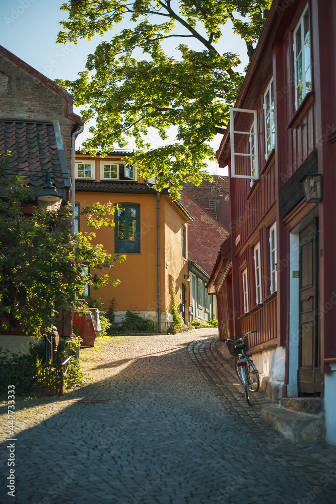 Old beautiful wooden houses in the central Oslo, Norway. Colorful architecture on a sunny summer day.