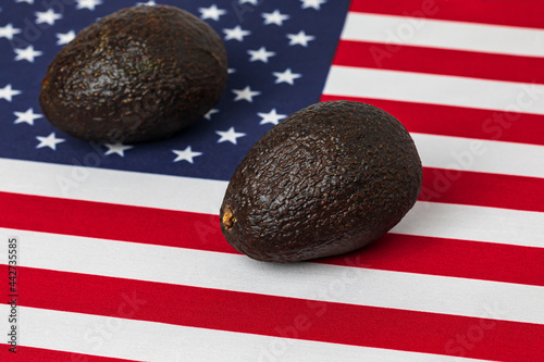 United States of America flag and avocados. Avocado farming trade, imports and exports concept photo