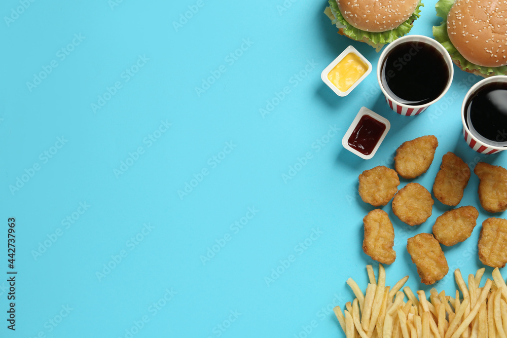 Flat lay composition with delicious fast food menu on light blue background. Space for text Flat lay composition with delicious fast food menu on light blue background. Space for text