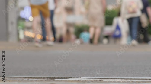 Ordinary people walking street sidewalk city in the summer urban life. Slow motion people walk in pedestrian street blur city life. Blurred persons walking sidewalk city abstract people unrecognizable