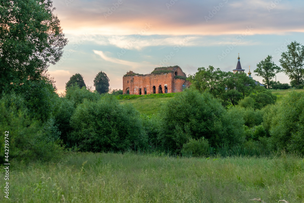 A view from a distance of The Dilapidated Church of the Intercession The Most Holy Theotokos on a high hill in the village of Lubyanki, Orel region, Russia