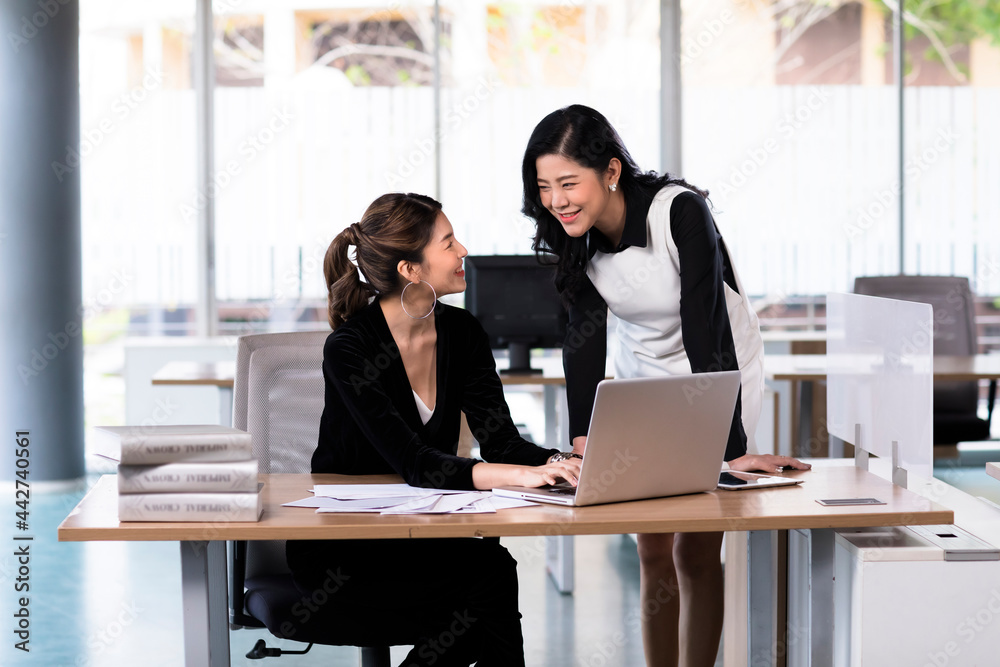 Asia cheerful businesswoman working at the table in office Asia cheerful businesswoman working at the table in office