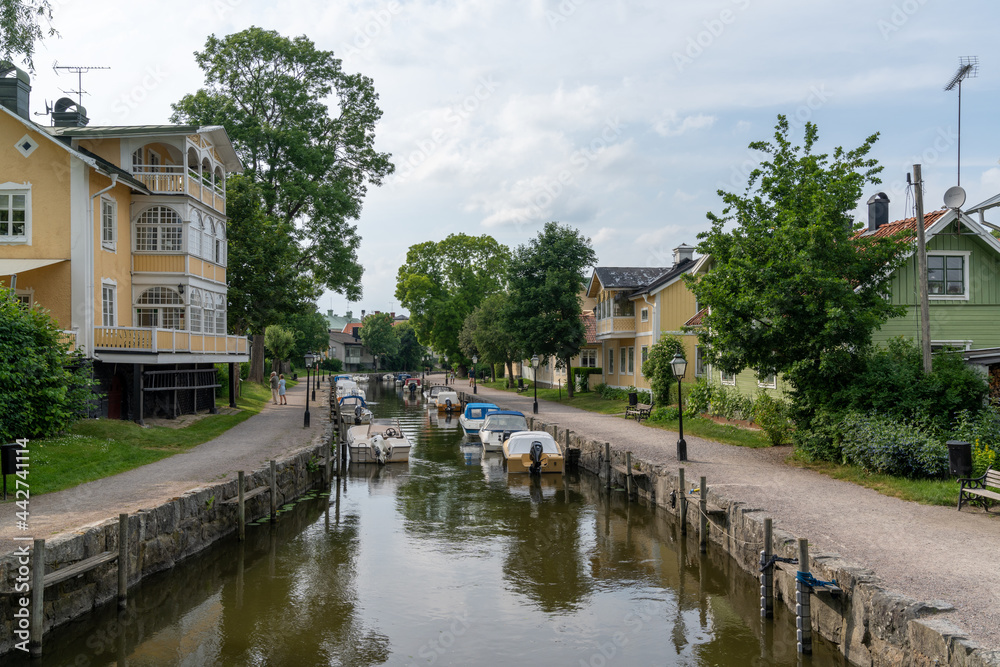 many boats line the canals of the harbor front in the idyllic Swedish village of Trosa