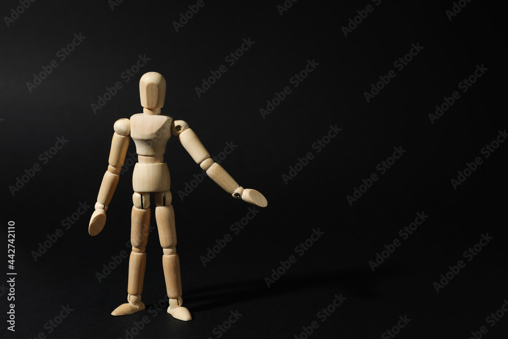 Wooden human model on black background, space for text. Mini mannequin Wooden human model on black background, space for text. Mini mannequin