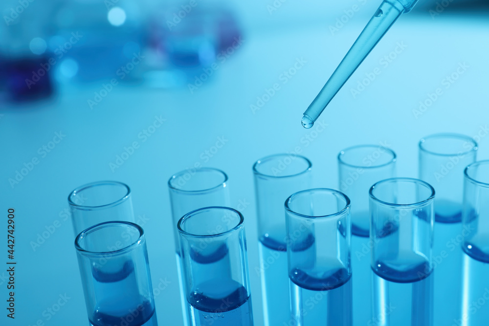 Dripping reagent into test tube with blue liquid, closeup. Laboratory analysis Dripping reagent into test tube with blue liquid, closeup. Laboratory analysis