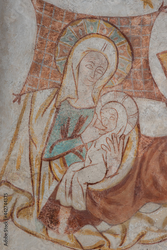Ancient wall-painting of Virgin Mary and the child on her laps in the stable
