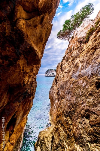 beautiful view between cliffs of blue sea and sky in menorca, spain