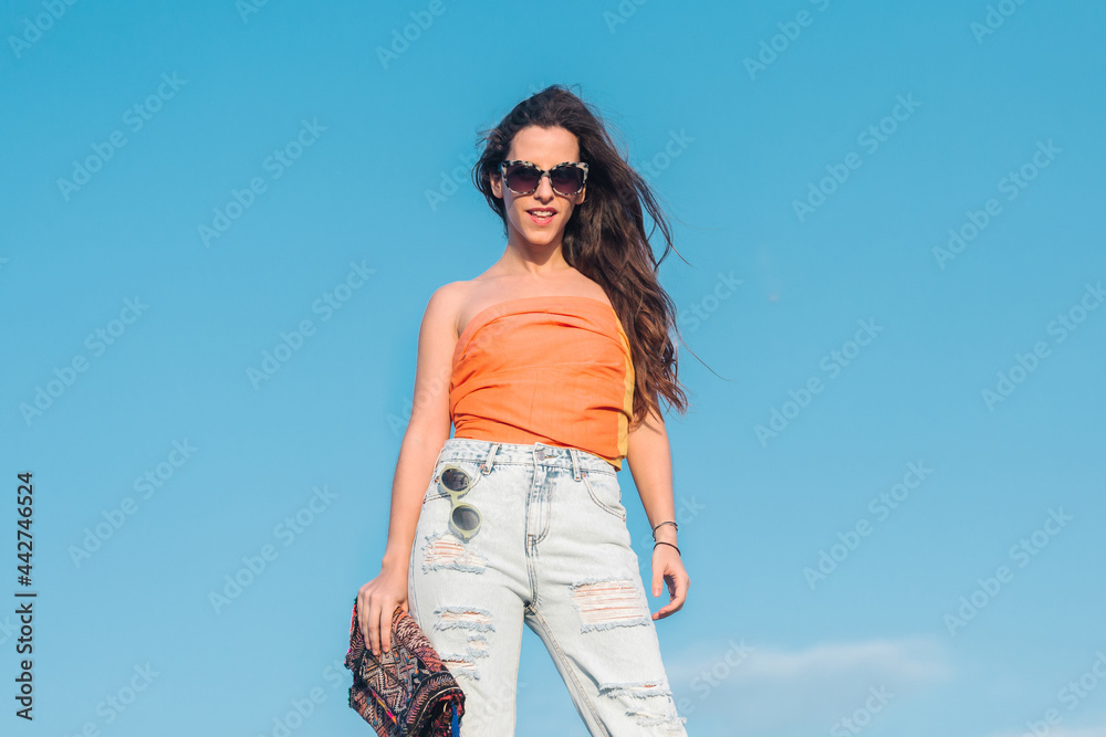 Happy woman in trendy summer wear and sunglasses Happy woman in trendy summer wear and sunglasses