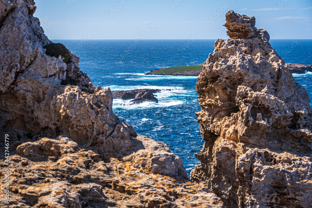 cliff and the blue sea in menorca, spain