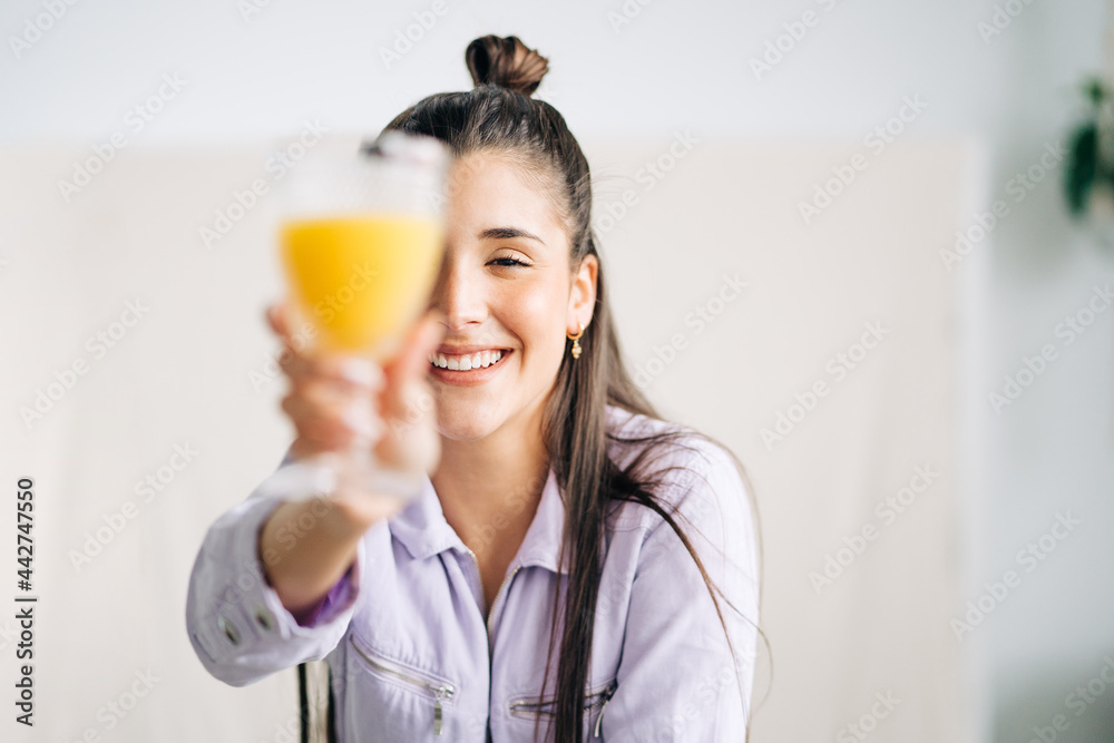 Happy woman with delicious orange juice in house Happy woman with delicious orange juice in house