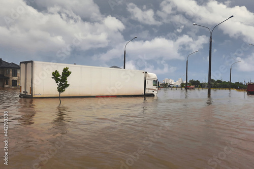 Car rides in heavy rain on a flooded road. Street of the city flooded after heavy rains. Show level of water flooding. Cars driving on the flood