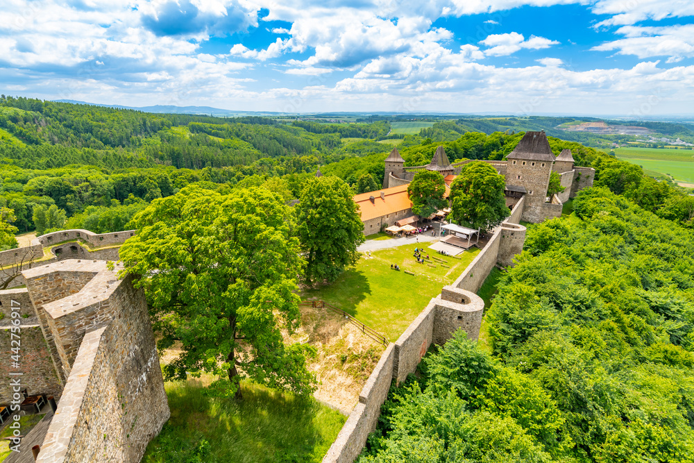Medieval castle Helfstyn, Czech Republic. Ancient castle in gothic style. Castle walls and interiors, beautiful old tower. Summer weather, blue sky with clouds. Famous trip destination.