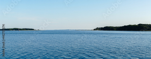 panorama landscape of the Baltic Sea with small islands covered in forest in the background