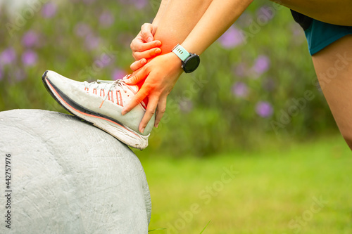 Sport woman has sore ankle from exercising training. It is a common injury for runners. Ankle pain, painful point.