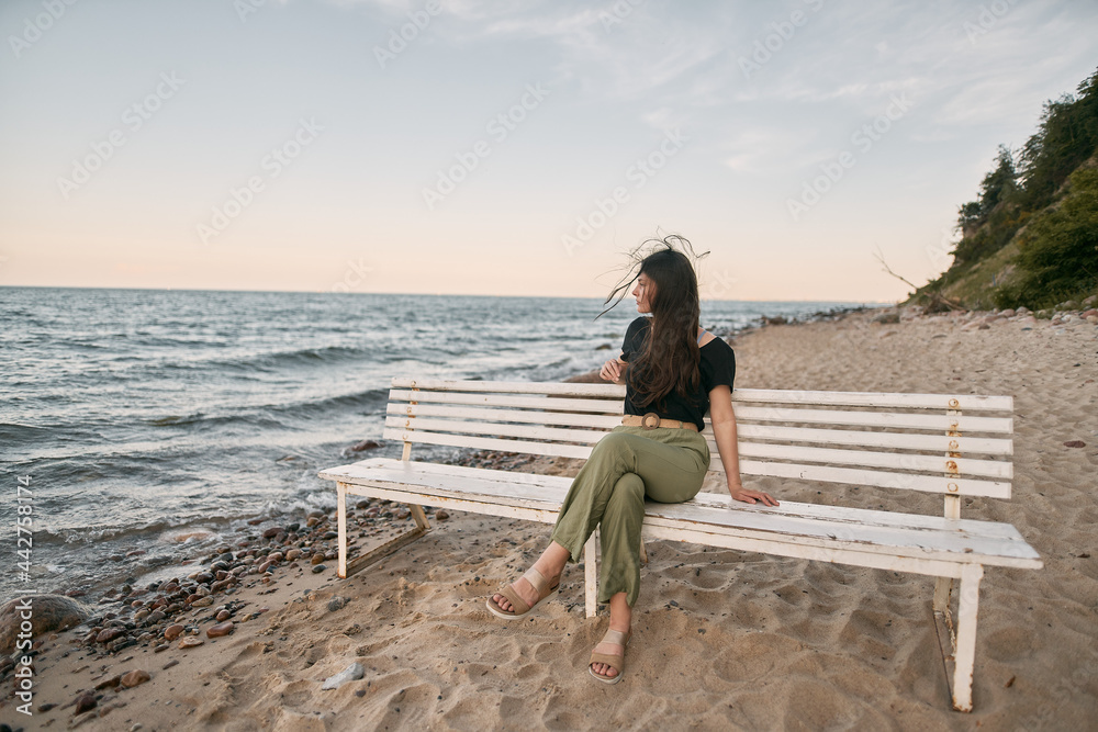 Lonely woman on the beach. COncept photo of depressed emotion and loneliness