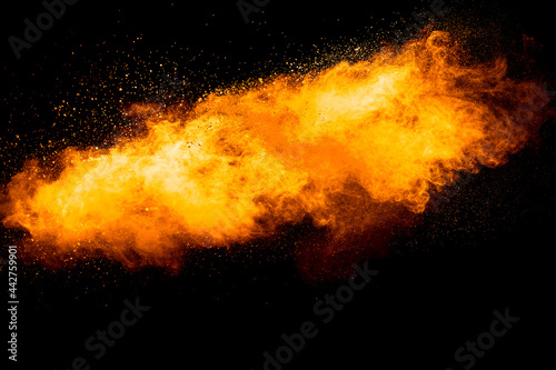 Orange color powder explosion on black background. © Pattadis
