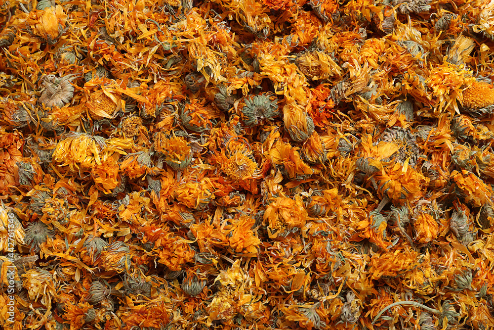 Pile of dry calendula flowers as background, top view Pile of dry calendula flowers as background, top view