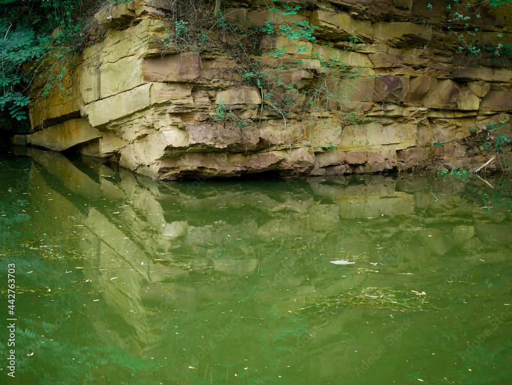 Fototapeta premium Rock stone mountain presented with water reflection image.