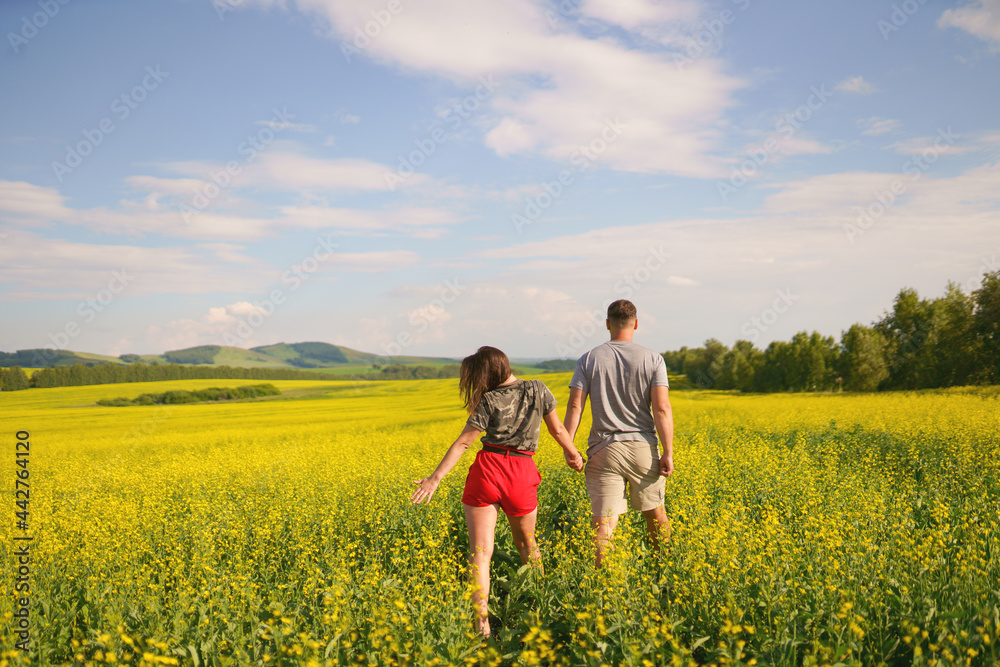 couple walking in blossom field