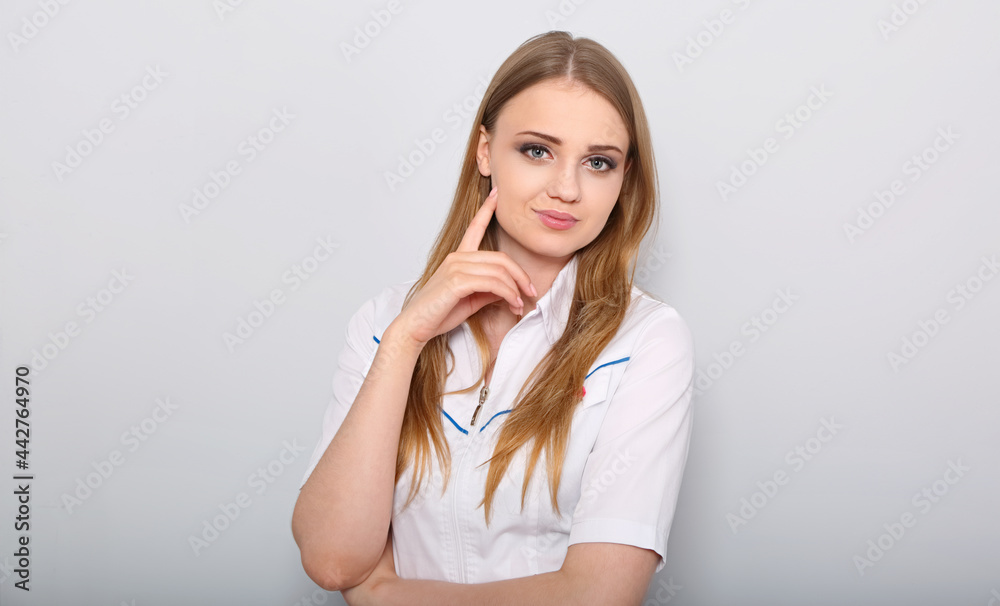 Beautifil family doctor blond woman friendly smiling in virology clinic with arms crossed in wear white lab coat stethoscope on blue color background. Closeup Beautifil family doctor blond woman friendly smiling in virology clinic with arms crossed in wear white lab coat stethoscope on blue color background. Closeup