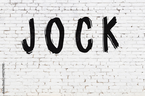Inscription jock painted on white brick wall