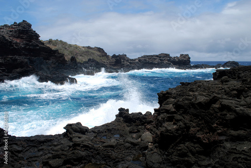 Waves Crashing Against Black Lava Rock in Hawaii