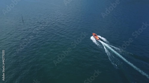 Motorboat moves in Como lake, aerial view from the drone
