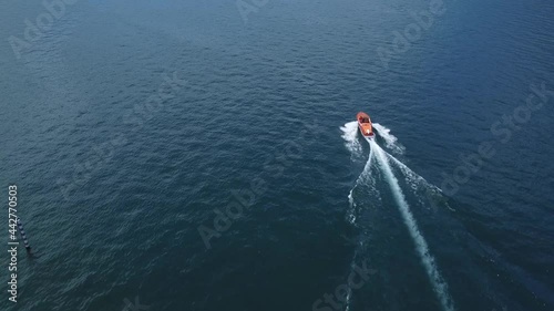 Motorboat moves in Como lake, aerial view from the drone