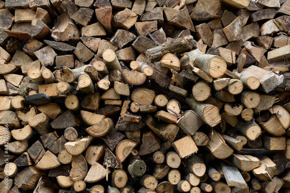 Wall of firewood, background of dry chopped firewood. Alternative fuel concept. Wooden background. Natural texture. Wall of firewood, background of dry chopped firewood. Alternative fuel concept. Wooden background. Natural texture.