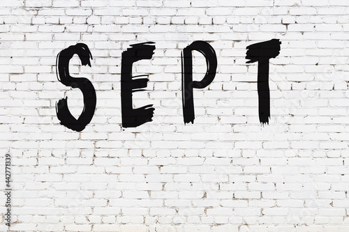 White wall with black paint inscription sept on it
