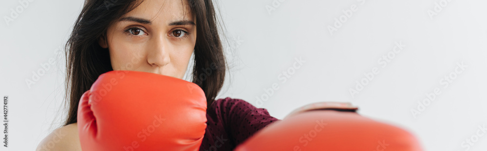armenian woman in red boxing gloves looking at camera on white, banner armenian woman in red boxing gloves looking at camera on white, banner