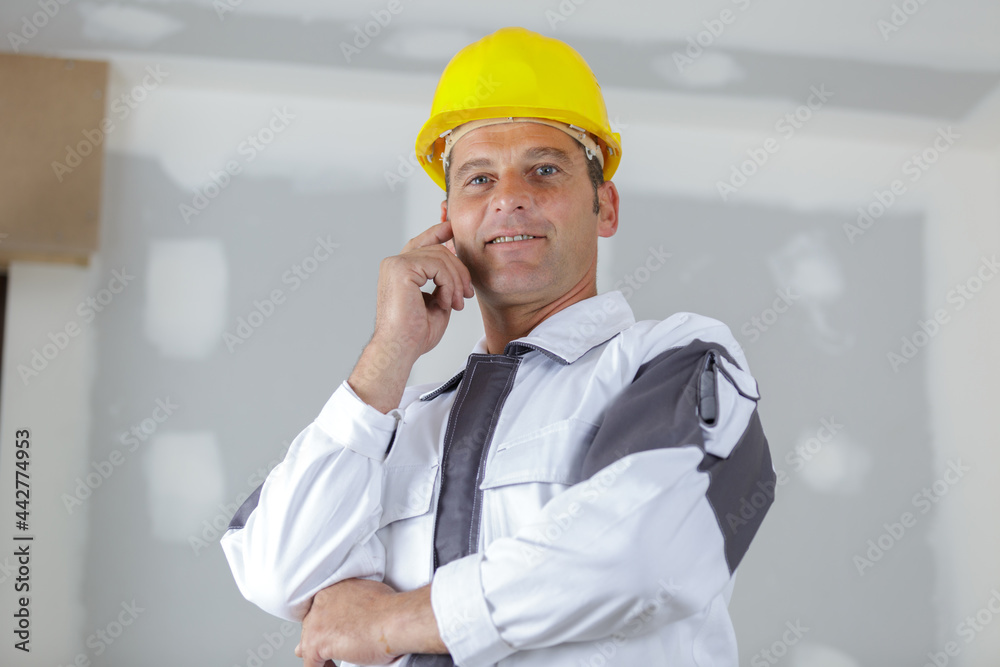 portrait of builder man standing indoors portrait of builder man standing indoors