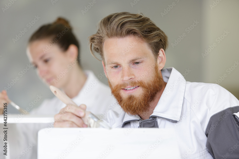 professional worker carefully painting object with white paint professional worker carefully painting object with white paint