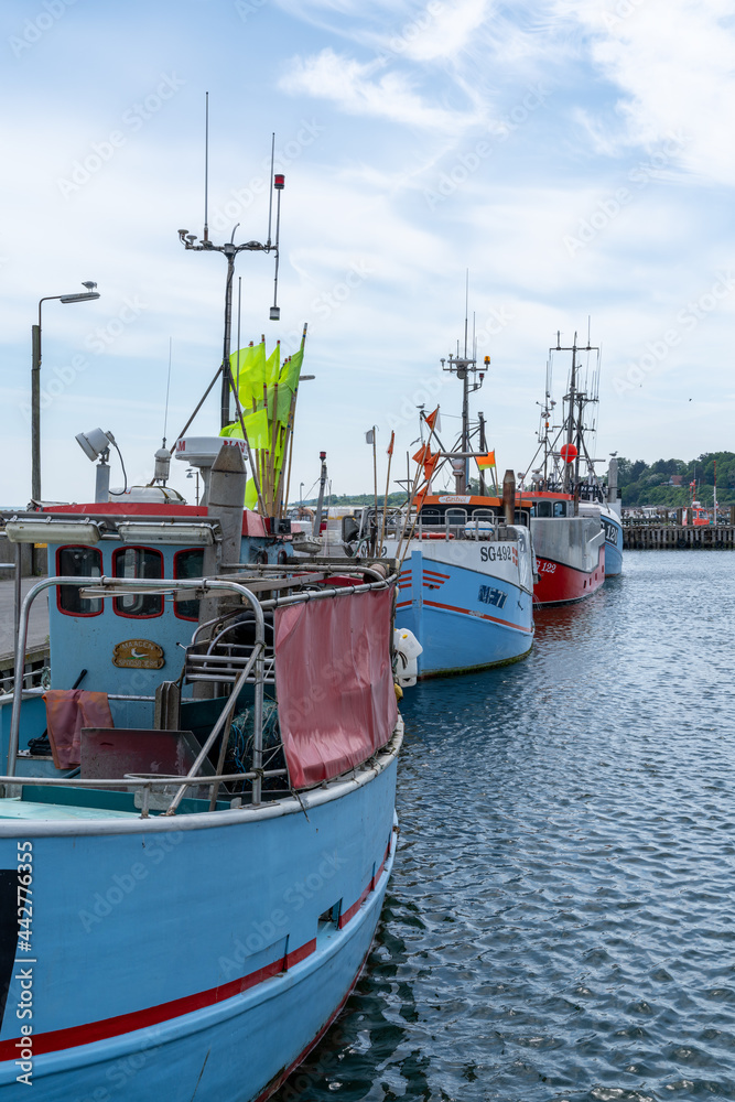vertical view of colorful fishing boats moored at the docks of the Spodsbjerg industrial harbor in South Denmark