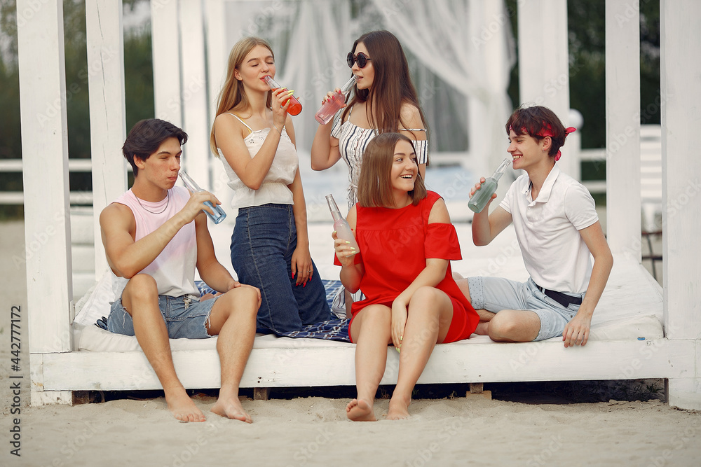 Fototapeta premium Friends have fun on a beach with drinks