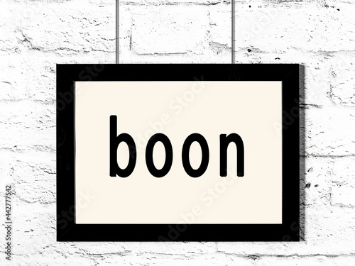 Bilde på lerret Black frame hanging on white brick wall with inscription boon