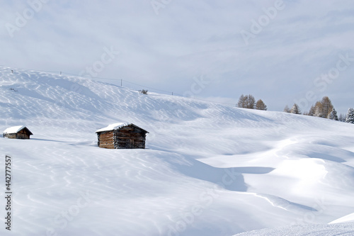 Wooden chalet on an empty snowy mountain © Judith