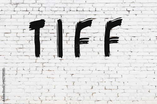 White wall with black paint inscription tiff on it