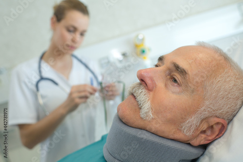 doctor with patient wearing neck brace