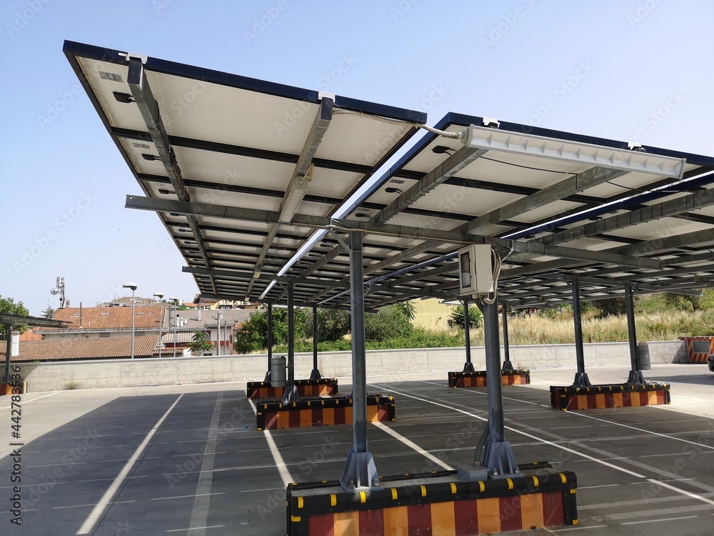 Naklejka premium parking spaces covered with solar panels at the shopping center