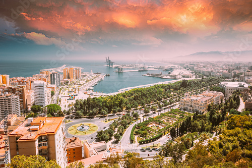 Malaga, Spain. Cityscape Elevated View Of Malaga In Sunny Summer Evening. Altered Sunset Sky