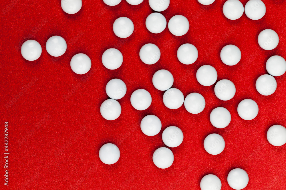 medicines for the treatment of diseases scattered on a red background medicines for the treatment of diseases scattered on a red background