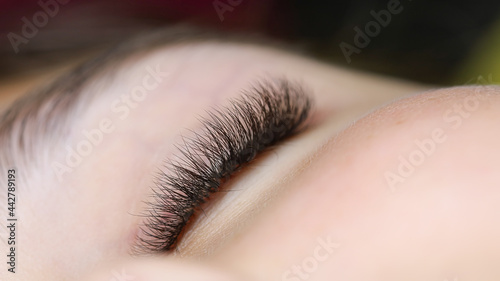 the finished result is an eyelash extension close-up of a young model lying on the couch © Roman