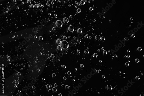 Close up macro Aloe vera gel cosmetic texture black background with bubbles. Charcoal gel skincare product. antibacterial liquid with aloe vera, moisturizing. Safe and environmental friendly.