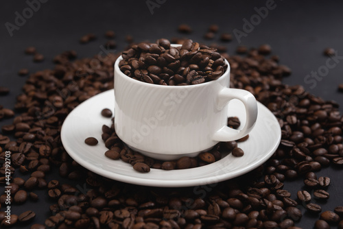 Coffee mug fulled of coffee beans