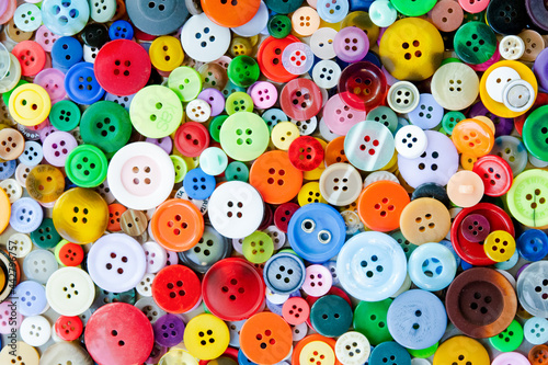 Colorful mixed sewing buttons background. Top view