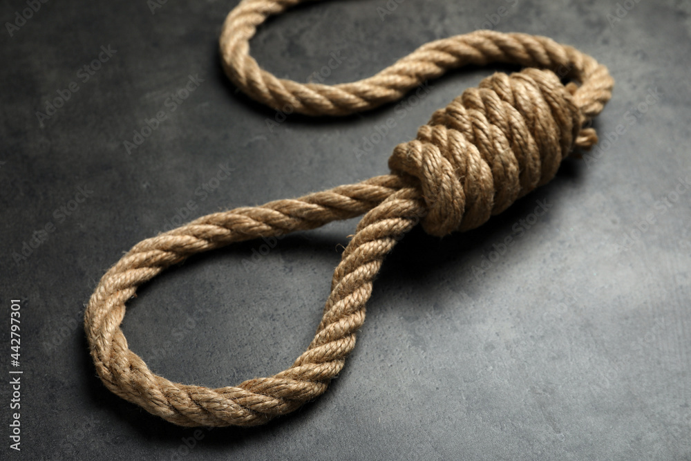 Rope noose with knot on grey table, closeup Rope noose with knot on grey table, closeup