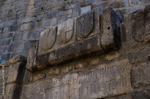 Ancient greek christian symbols on the old stone wall of the temple photo