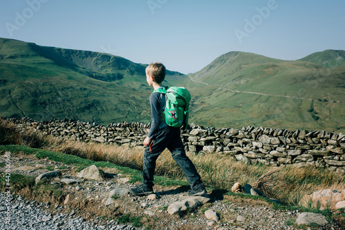 boy hiking the mountains in Snowdonia National Park on a beautiful day