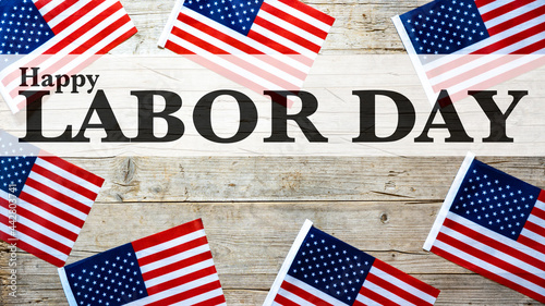 Happy Labor Day background banner greting card template - American flags and lettering, isolated on rustic wood texture, wooden table, top view photo